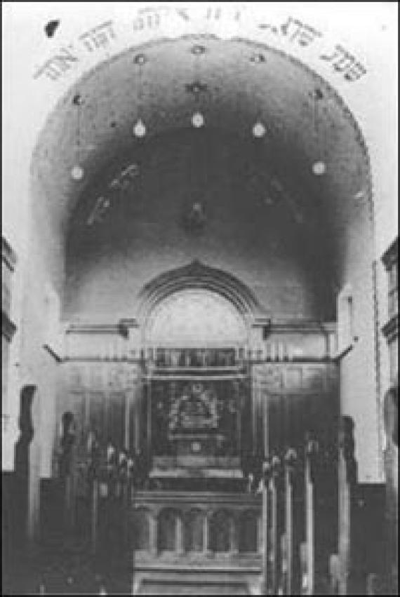 The black and white photo shows the pews on the left and right and just the altar, above which is a dome.