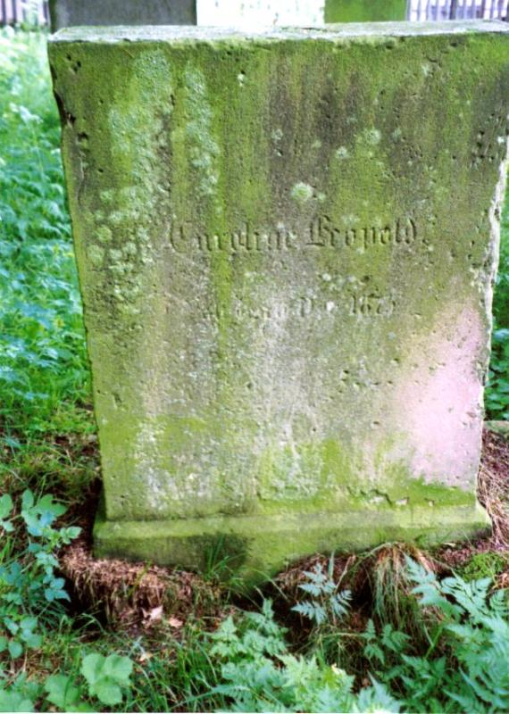 gravestone covered with verdigris