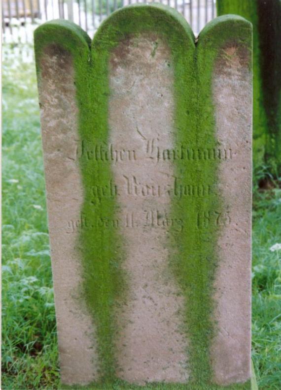 arched tombstone, covered with verdigris