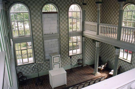 green decorated walls, striped pillars, simple altar