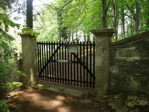 Wooden gate between two stone pillars