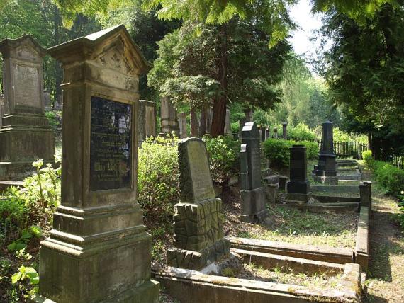 high gravestone with black plaque on it