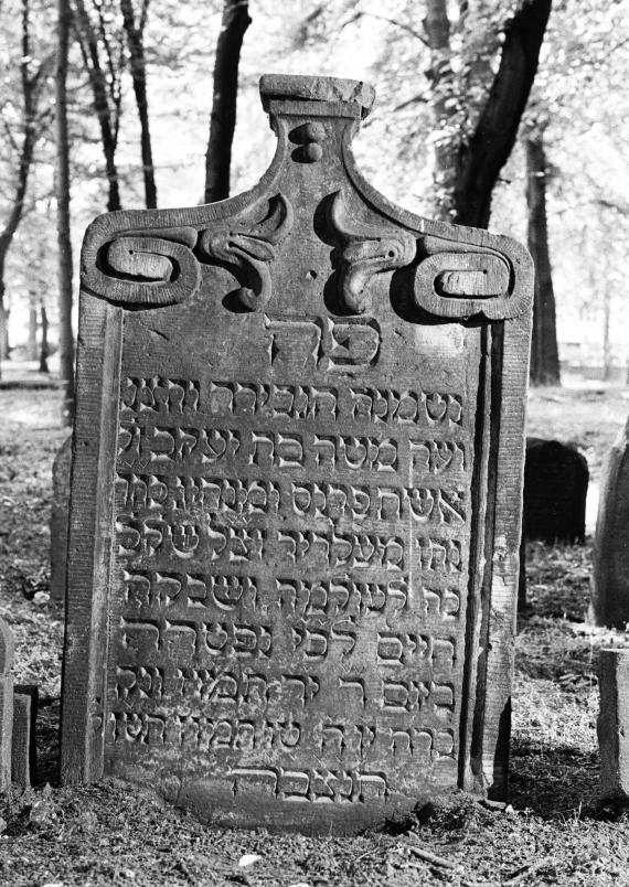 Black and white photo of the tombstone with Hebrew inscription