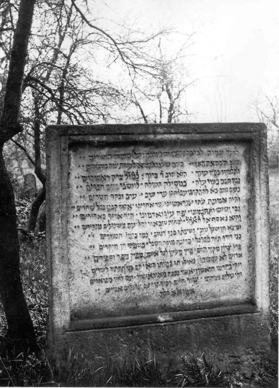 Black and white photo of the tombstone with Hebrew inscription