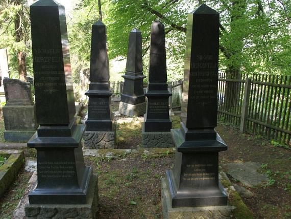 five high black grave stelae, two in the foreground