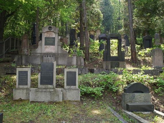 three gravestones with black plates on them