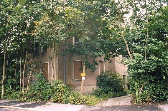 multi-storey building, hidden by trees