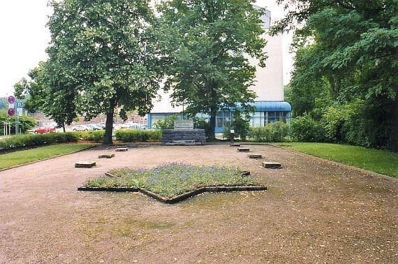 Flower bed in the shape of a Star of David on an open space, left and right lawns