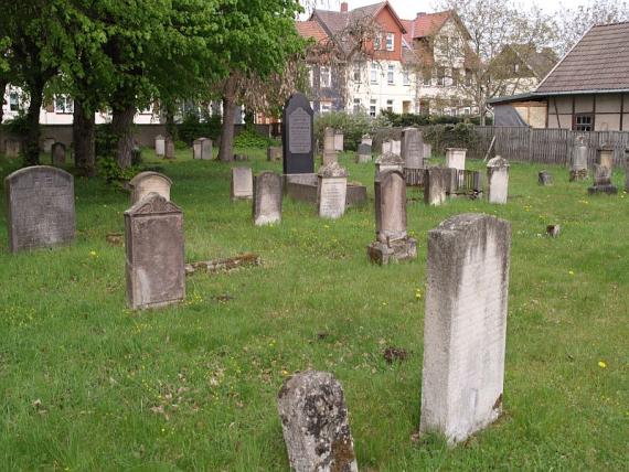 weathered gravestones on lawn, graves no longer bordered