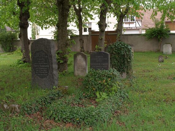 gravestones overgrown with ivy