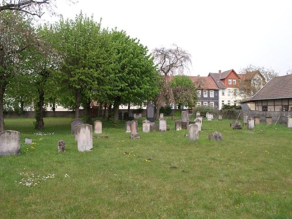 left back trees, in front of it on the lawn gravestones