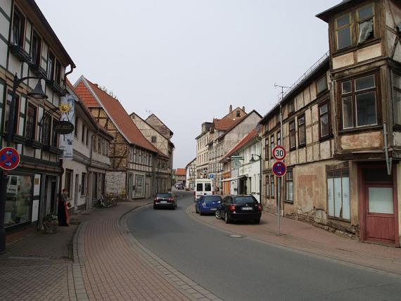 Einbahnstraße verläuft in eine Linkskurve, heruntergekommene Fachwerkhäuser links und rechts