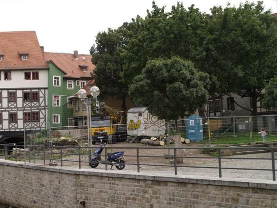 cordoned off construction area, behind it the buildings