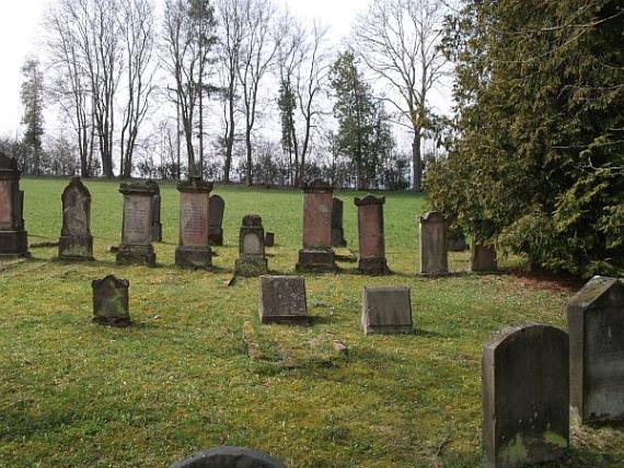 several rows of gravestones, including older ones on grass