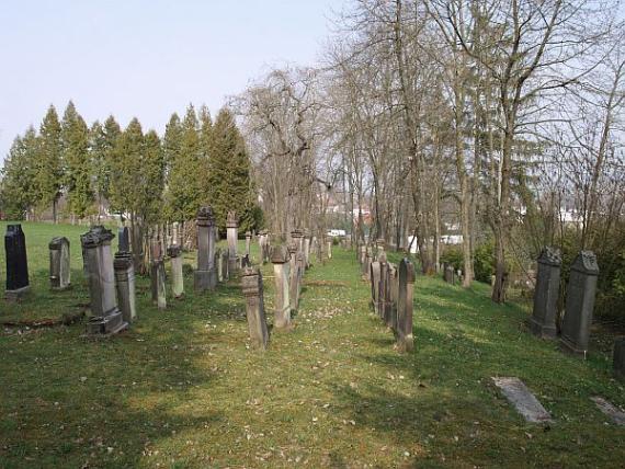 five rows of gravestones on the hill