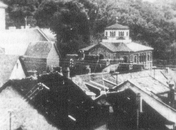 Black and white photo: view from a roof, almost square foundation stone building