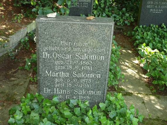 rough granite with the inscription: "Here rest beloved and unforgotten..."