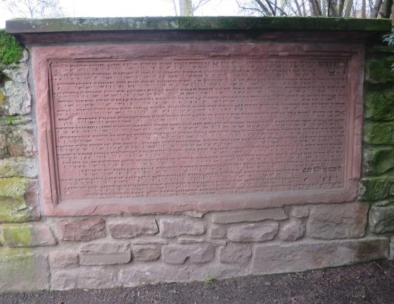 Prayer for the dead at the cemetery wall