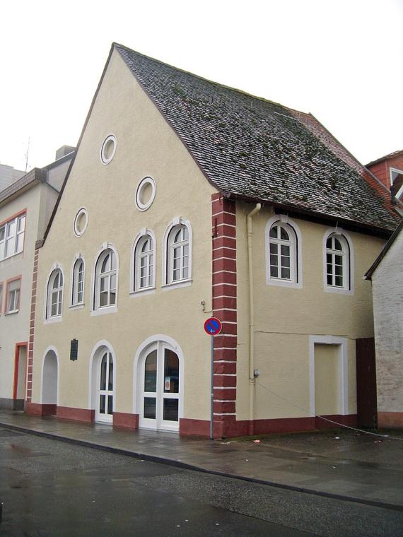 multi-storey building with three round recesses in the gable