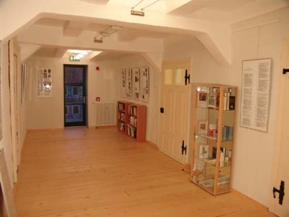 bright room with exhibits and text panels on the walls