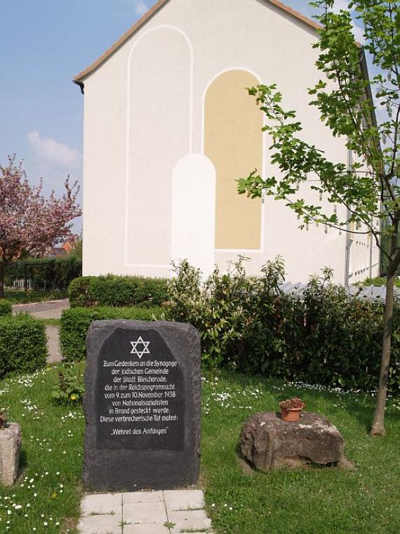 closer picture of the stone with a stone of the synagogue right next to it