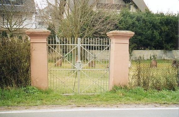 Iron gate between two stone pillars