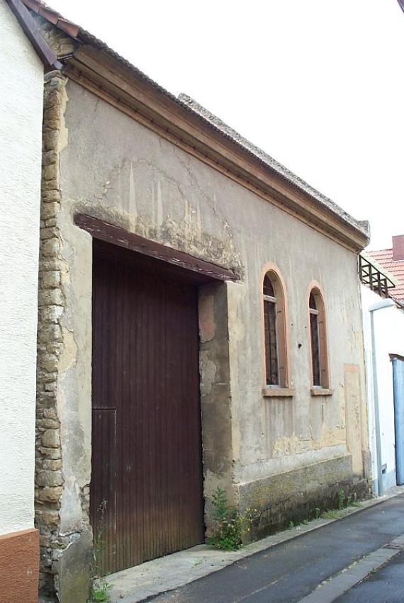 dilapidated building with large wooden gate