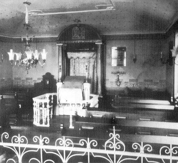 Black and white photo: benches in front of the shrine