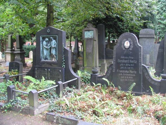 dark gravestones, with a Star of David on the left. Around trees