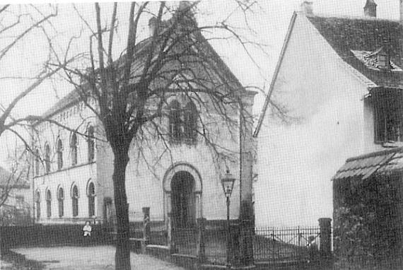 narrow, two-storey building with arched gateway