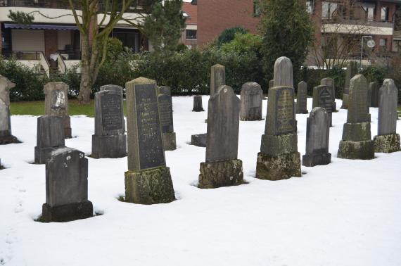 View of gravestones on the snow covered cemetery