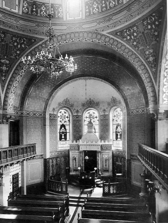 Interior of a large church with a richly decorated wall