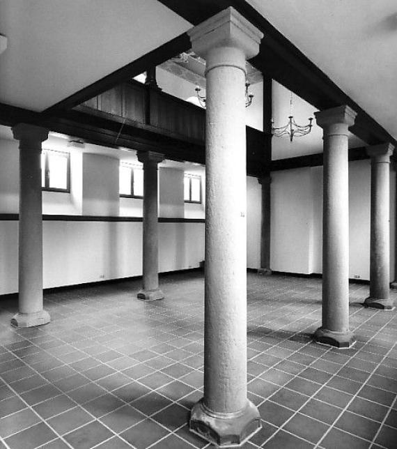 Black and white image, interior with four columns