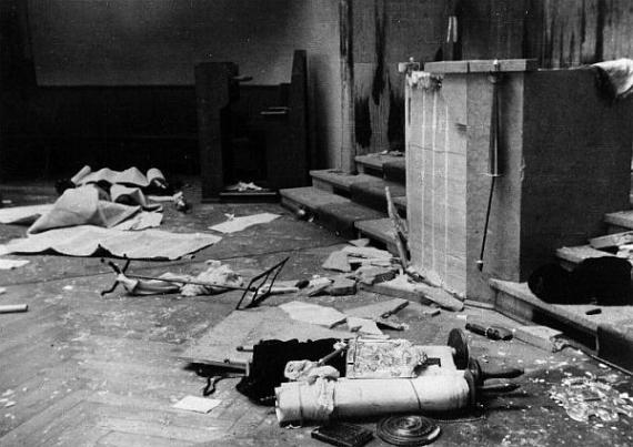 a desecrated prayer scroll in the devastated synagogue