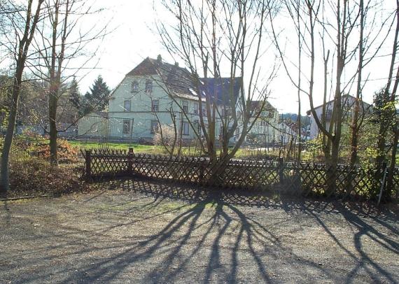 vacant lot, residential buildings in the background