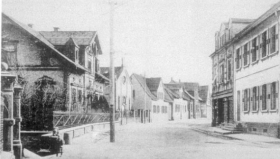 Black and white photo: synagogue difficult to recognize, round window in gable