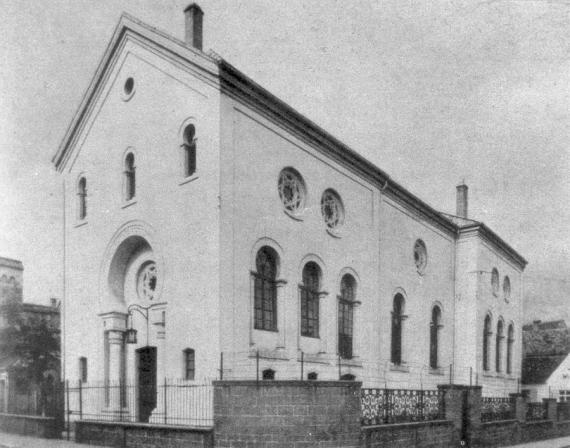 großes, weißes Gebäude mit vielen Fenstern und einem spitzen Dach