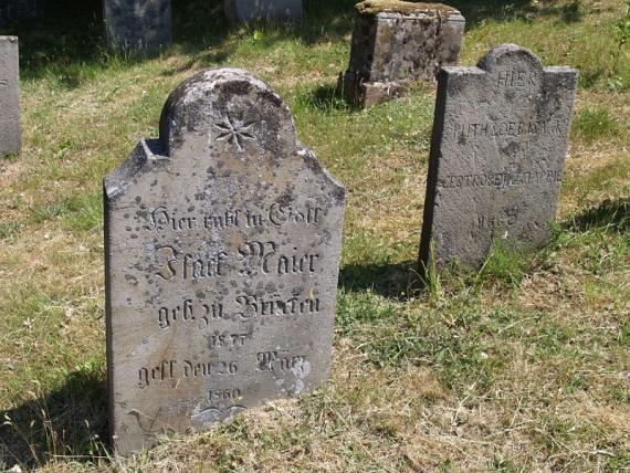 several weathered gravestones