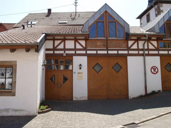 wooden entrance doors, two-story building, white plastered with transoms in the facade