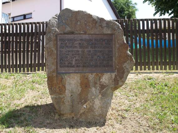 rough boulder with iron memorial plaque on it