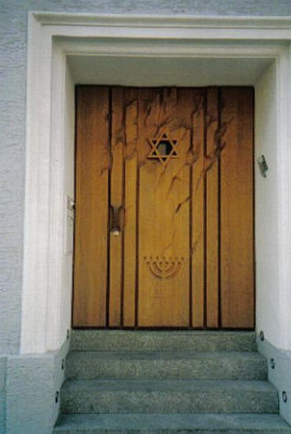 Stairs to the entrance gate made of wood with Star of David and seven-branched candelabra