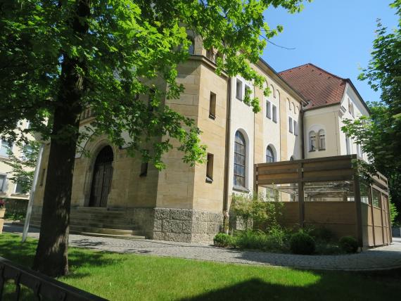 multi-storey house with yellow stones and a wooden gate