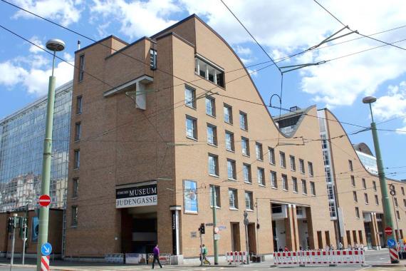 Imposing building with curved roof on a traffic road