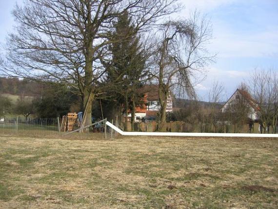 Angenrod cemetery with white marker for preserved gravestones.