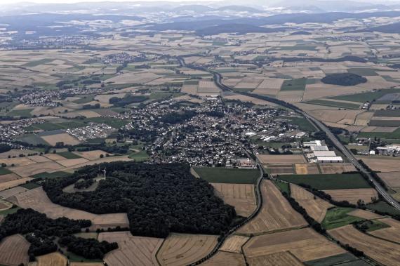 Bird's eye view of Gudensberg, showing hilly field landscape with village