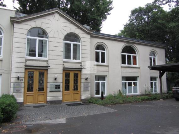 Large white bourgeois two-story house with many windows and two doors