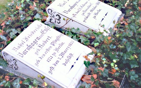 Two square gravestones of the Varnhagen couple lie on the meadow