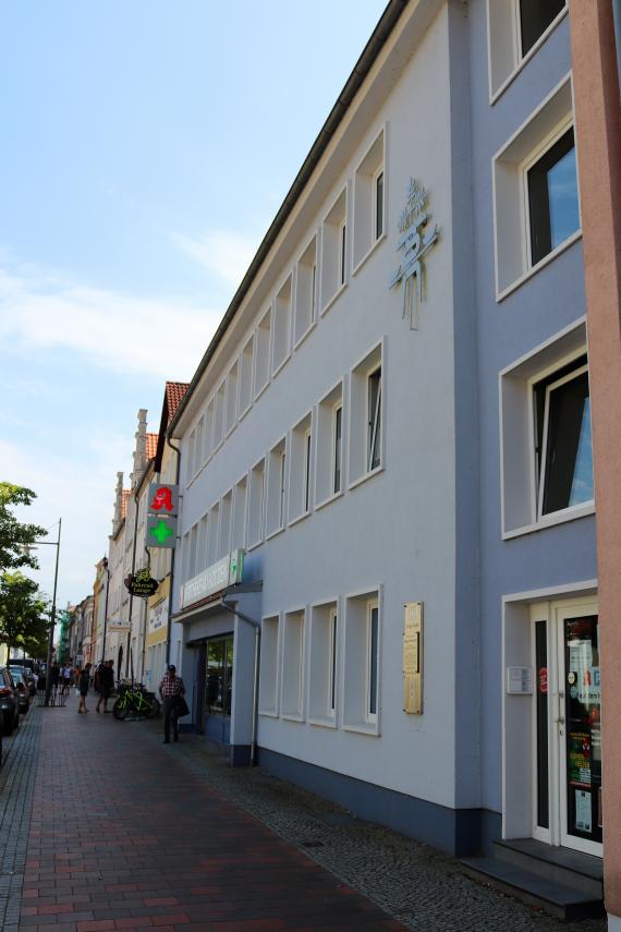 View of a long sidewalk, on the right a row of houses