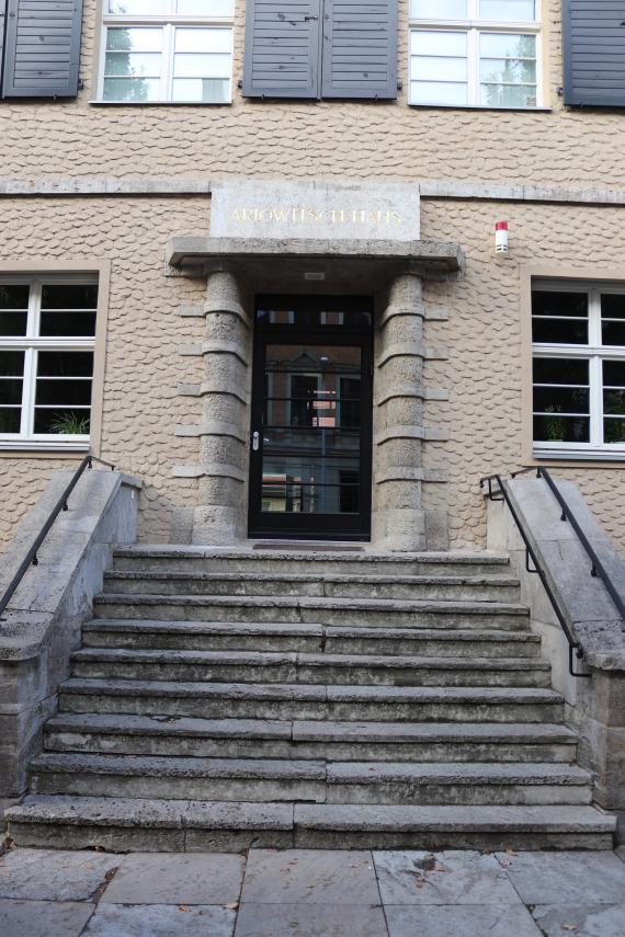 Entrance of the Ariovich House. From the sidewalk a small staircase leads up to the door.