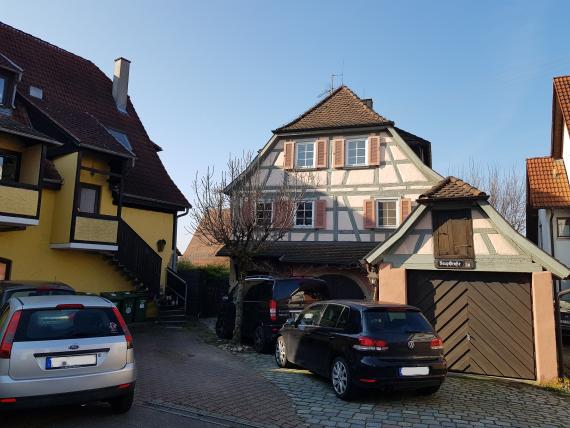 Gable half-timbered house with crippled hipped roof